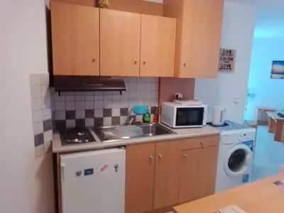 a small kitchen with a sink and a microwave at GT Apartment in Rhodes Town