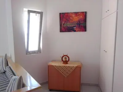 a room with a table and a painting on the wall at GT Apartment in Rhodes Town