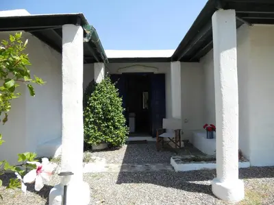 a porch of a house with a christmas tree at Arancio independent room in Ecovilla on the beach in Apolakkiá