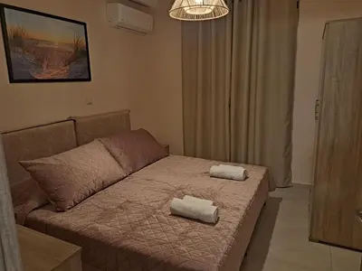 a room with a bed with two towels on it at Déjà Blue in Archangelos