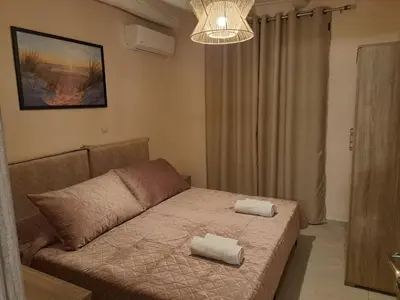 a living room with a couch with two towels on it at Déjà Blue in Archangelos