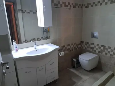 a bathroom with a sink and a toilet at Déjà Blue in Archangelos