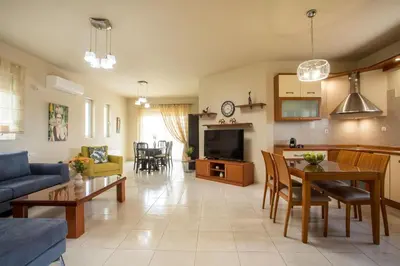 a living room with a couch and a table at Villa Merelia in Afantou