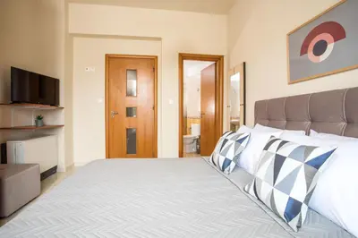a bedroom with a bed and a flat screen tv at Villa Merelia in Afantou