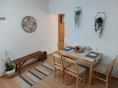 a dining room with a wooden table and chairs at Afandou Square Apartment in Afantou