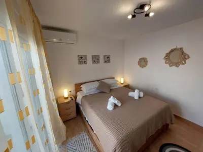 a bedroom with a bed with towels on it at Afandou Square Apartment in Afantou