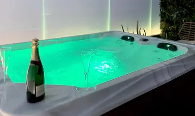 a bottle of champagne and a glass in a tub at Rodosrooms in Rhodes Town