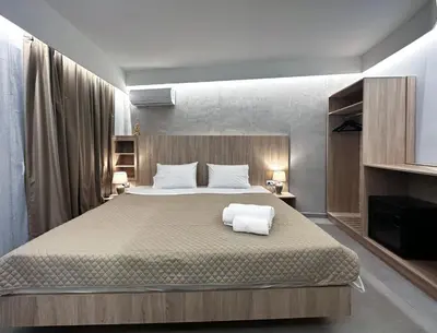 a bedroom with a bed with two towels on it at Rodosrooms in Rhodes Town