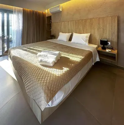 a bedroom with a large bed with towels on it at Rodosrooms in Rhodes Town