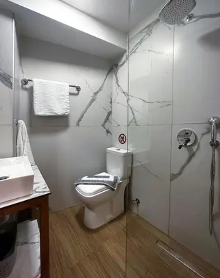 a bathroom with a toilet and a glass shower at Rodosrooms in Rhodes Town