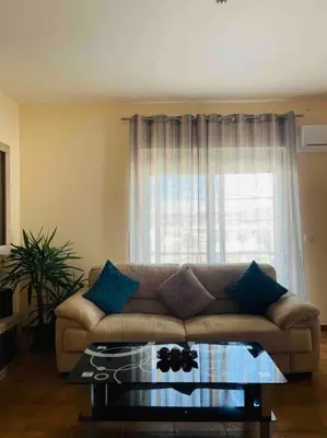 a living room with a couch and a window at George House in Archangelos