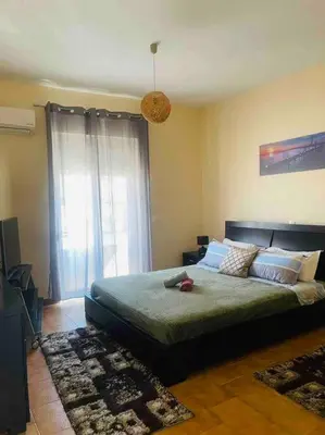 a bedroom with a bed and a large window at George House in Archangelos