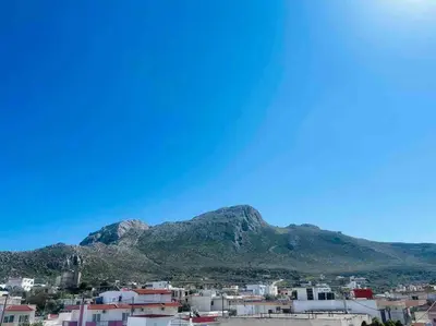 a view of a city with mountains in the background at George House in Archangelos