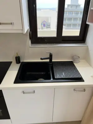a kitchen with a sink and a window at 2-Luxury jacuzzi white suite by the sea in Rhodes Town