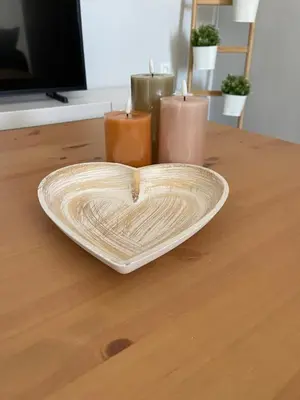 a heart shaped plate on a table with candles at Vixen Apartment Studio 2 in Theologos