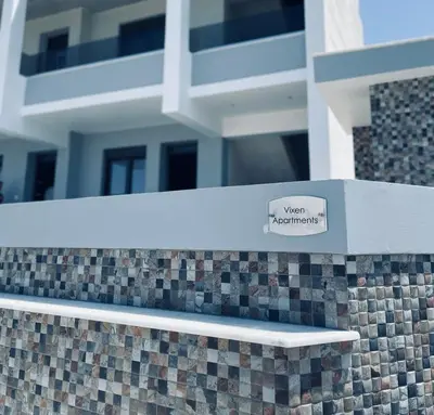 a sign on a wall with a building in the background at Vixen Apartment Studio 2 in Theologos
