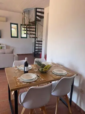 a dining room table with plates and wine glasses at Villa Calliope Lardos in Lardos