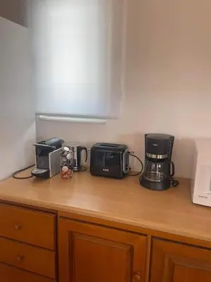 a kitchen counter with two coffees and a coffee maker at Villa Calliope Lardos in Lardos