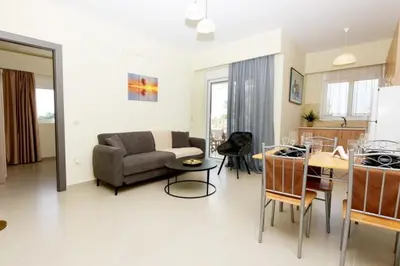 a living room with a couch and a table at Elli Garden View - Spacious Fully Equipped Apartment in Kremasti
