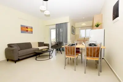 a living room with a couch and a table at Elli Garden View - Spacious Fully Equipped Apartment in Kremasti
