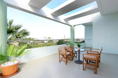 a balcony with chairs and a table with a view at Elli Garden View - Spacious Fully Equipped Apartment in Kremasti