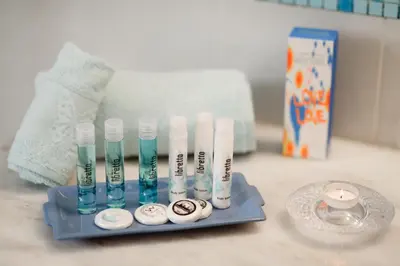 a group of toothbrushes on a blue tray on a counter at Marilena Mare Seaside & Jacuzzi House 50meters from sea in Ialyssos