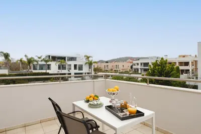 a balcony with a table with fruit on it at Marilena Mare Seaside & Jacuzzi House 50meters from sea in Ialyssos