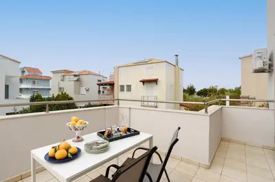 a balcony with a table with fruit on it at Marilena Mare Seaside & Jacuzzi House 50meters from sea in Ialyssos