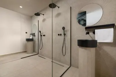 a bathroom with a shower with a glass door at Mirena Luxury Living-Casa Di Ria in Afantou