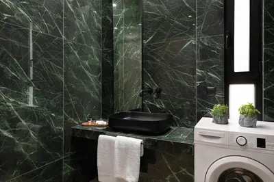 a bathroom with a sink and a washing machine at Mirena Luxury Living-Casa Di Ria in Afantou