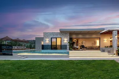 a villa with a swimming pool at night at Mirena Luxury Living-Casa Di Ria in Afantou