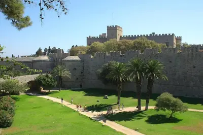 a castle with palm trees and a wall at Ioli's Home - Medieval Town in Rhodes Town