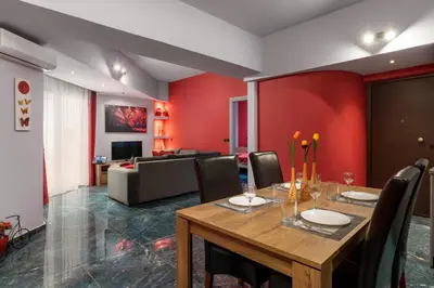 a dining room with a table and a couch at Fata Morgana Apartment in Ialyssos