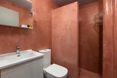 a bathroom with a white toilet and a sink at Fata Morgana Apartment in Ialyssos