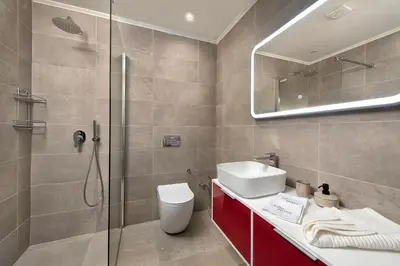 a bathroom with a shower and a toilet and a sink at Villa Myrto in Ialyssos
