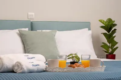 a tray of breakfast foods and drinks on a bed at Villa Odysseas in Ialyssos