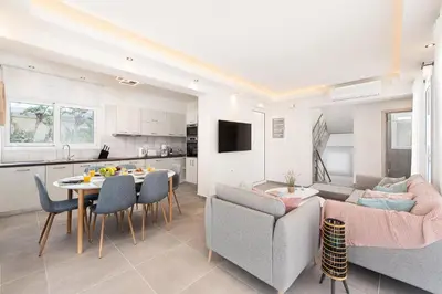 a kitchen and a living room with a table and chairs at Villa Odysseas in Ialyssos
