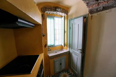 a small kitchen with a sink and a window at Say Yes Symi House in Symi