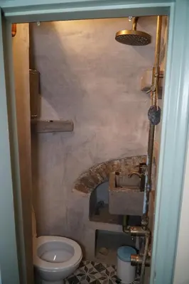 a small bathroom with a toilet and a sink at Say Yes Symi House in Symi