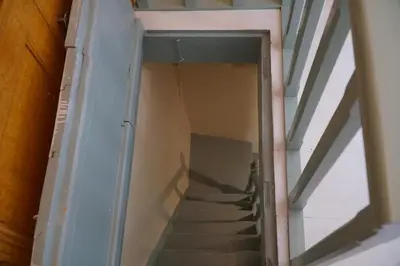 a stairway in a building with a glass door at Say Yes Symi House in Symi