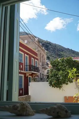 a view out of a window of a building at Say Yes Symi House in Symi