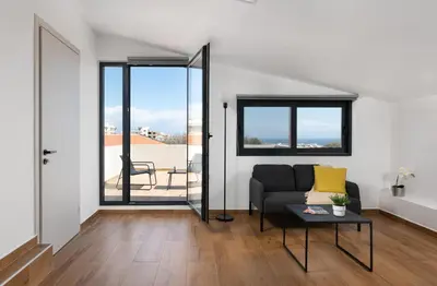 a living room with a couch and a table at City Art Villa in Asgourou