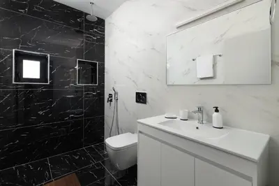 a bathroom with a white toilet and a sink at City Art Villa in Asgourou