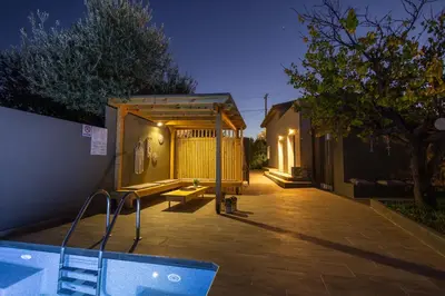 a small house with a pool in a yard at City Art Villa in Asgourou