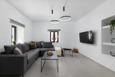 a living room with a couch and a table at City Art Villa in Asgourou