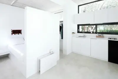a white kitchen with a sink and a window at White dream summer house in Ialyssos