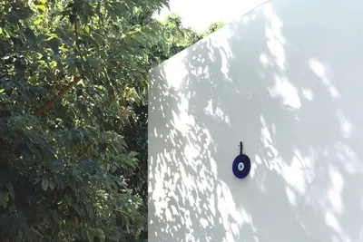 a wall with a computer mouse next to a tree at White dream summer house in Ialyssos
