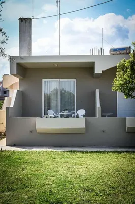 a house with two chairs and a table on the side at Stacy's Studios in Kremasti