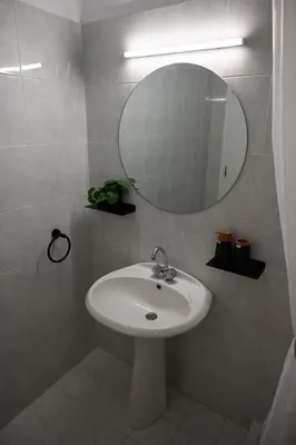 a bathroom with a white sink and a mirror at Stacy's Studios in Kremasti