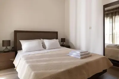 a bedroom with a large bed with towels on it at gefiraki apartment in Koskinou